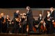 Conductor Dr. Pierce shakes hands with NHS Concert Master Joseph MacNeill