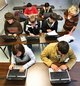 Wellborn High School physics teacher Mary Jones works with her students who are using laptops in class. Photo: Stephen Gross/The Anniston Star