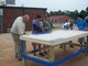 Mr. Parks instructs students in painting the new tables.